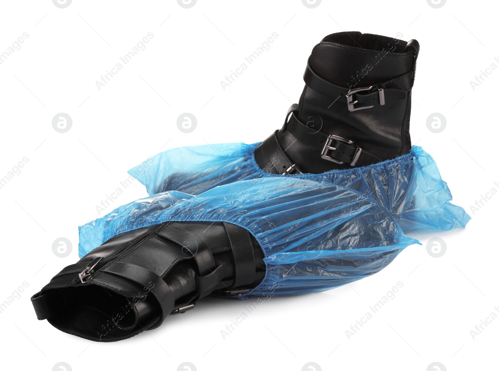 Photo of Women's boots in blue shoe covers isolated on white