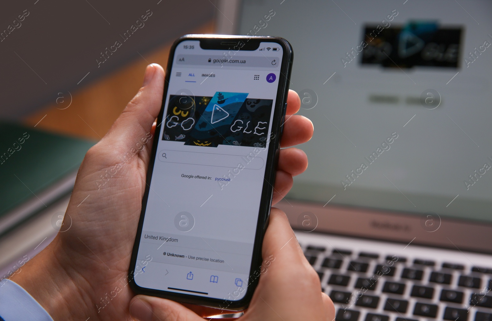 Photo of MYKOLAIV, UKRAINE - OCTOBER 31, 2020: Person using Google search engine on smartphone at table, closeup