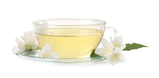 Photo of Aromatic herbal tea in glass cup and flowers isolated on white