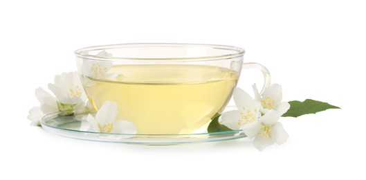 Aromatic herbal tea in glass cup and flowers isolated on white