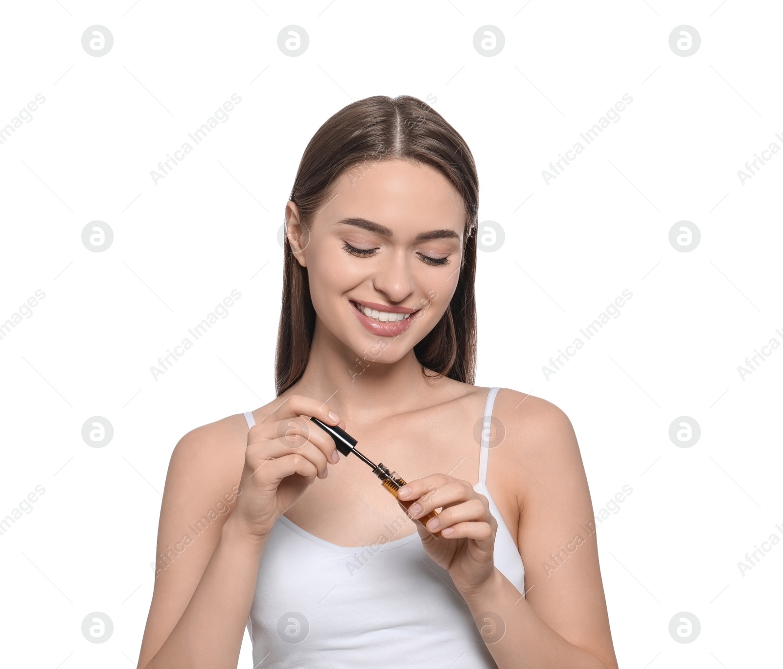 Photo of Young woman with eyelash oil on white background