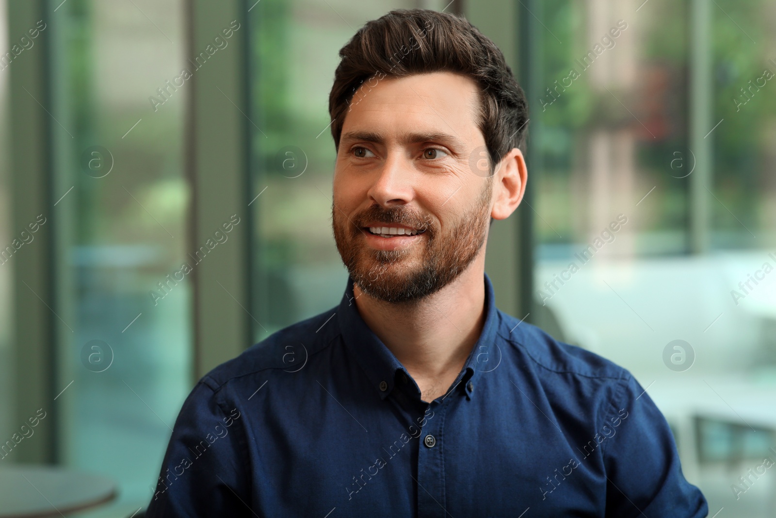 Photo of Portrait of handsome stylish man in office