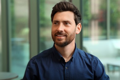 Photo of Portrait of handsome stylish man in office