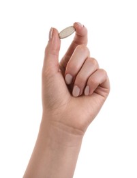 Photo of Woman holding vitamin pill on white background, closeup. Health supplement