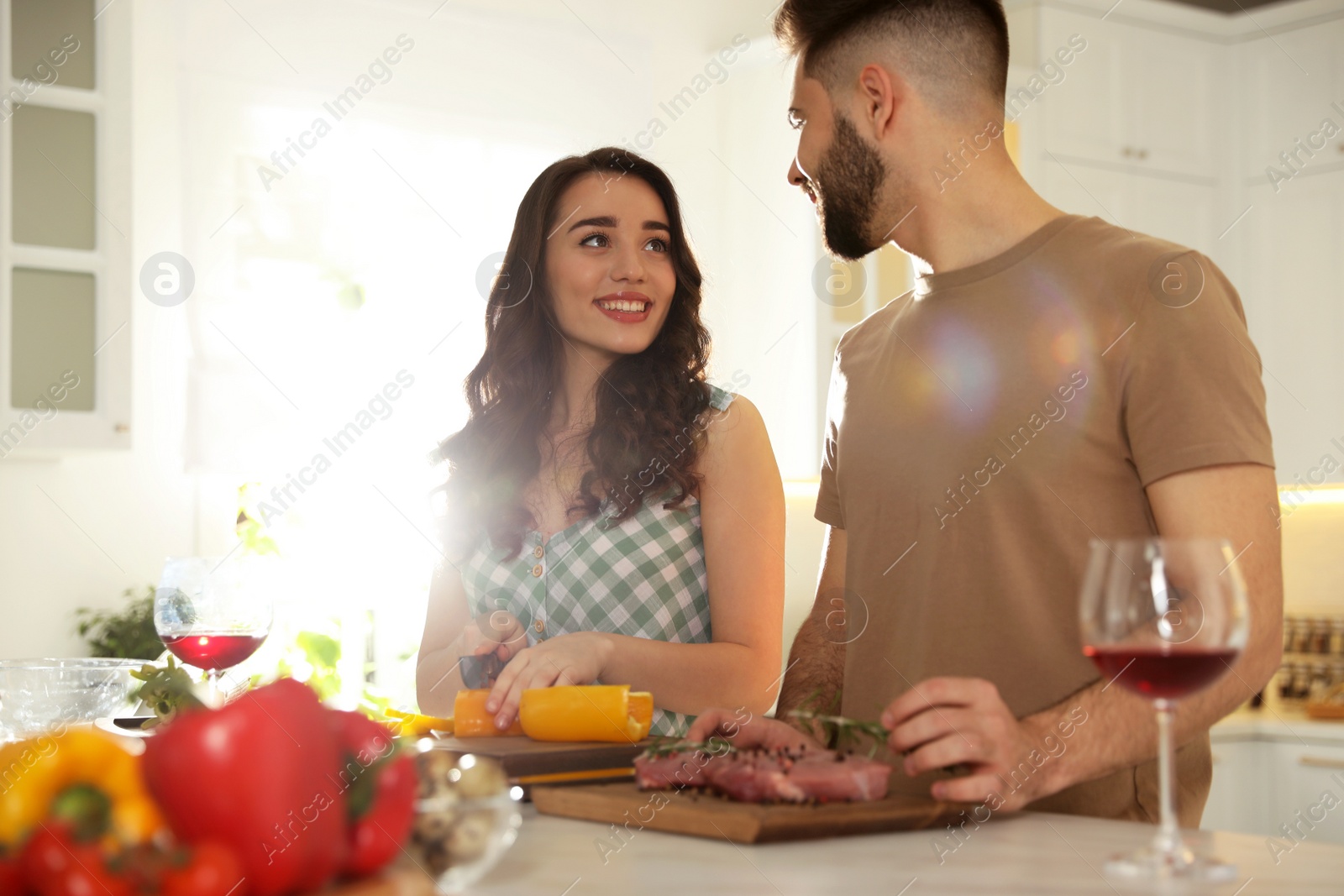 Photo of Lovely young couple cooking together in kitchen