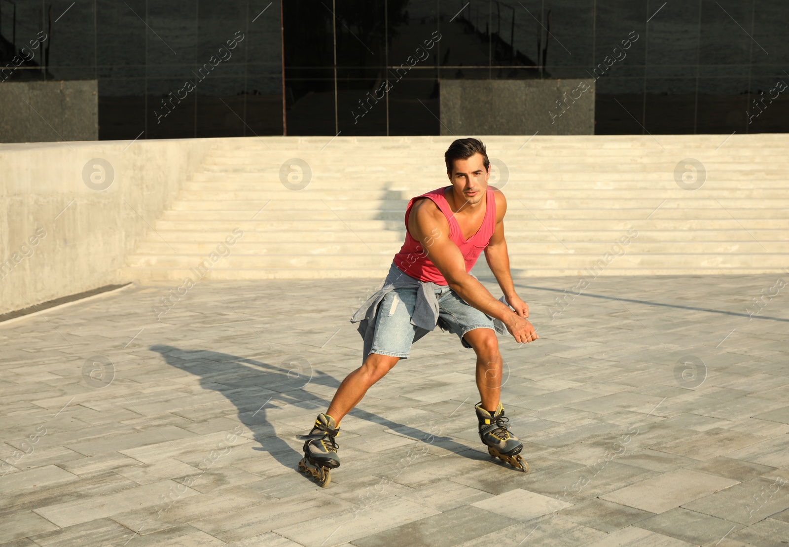 Photo of Handsome young man roller skating on city street