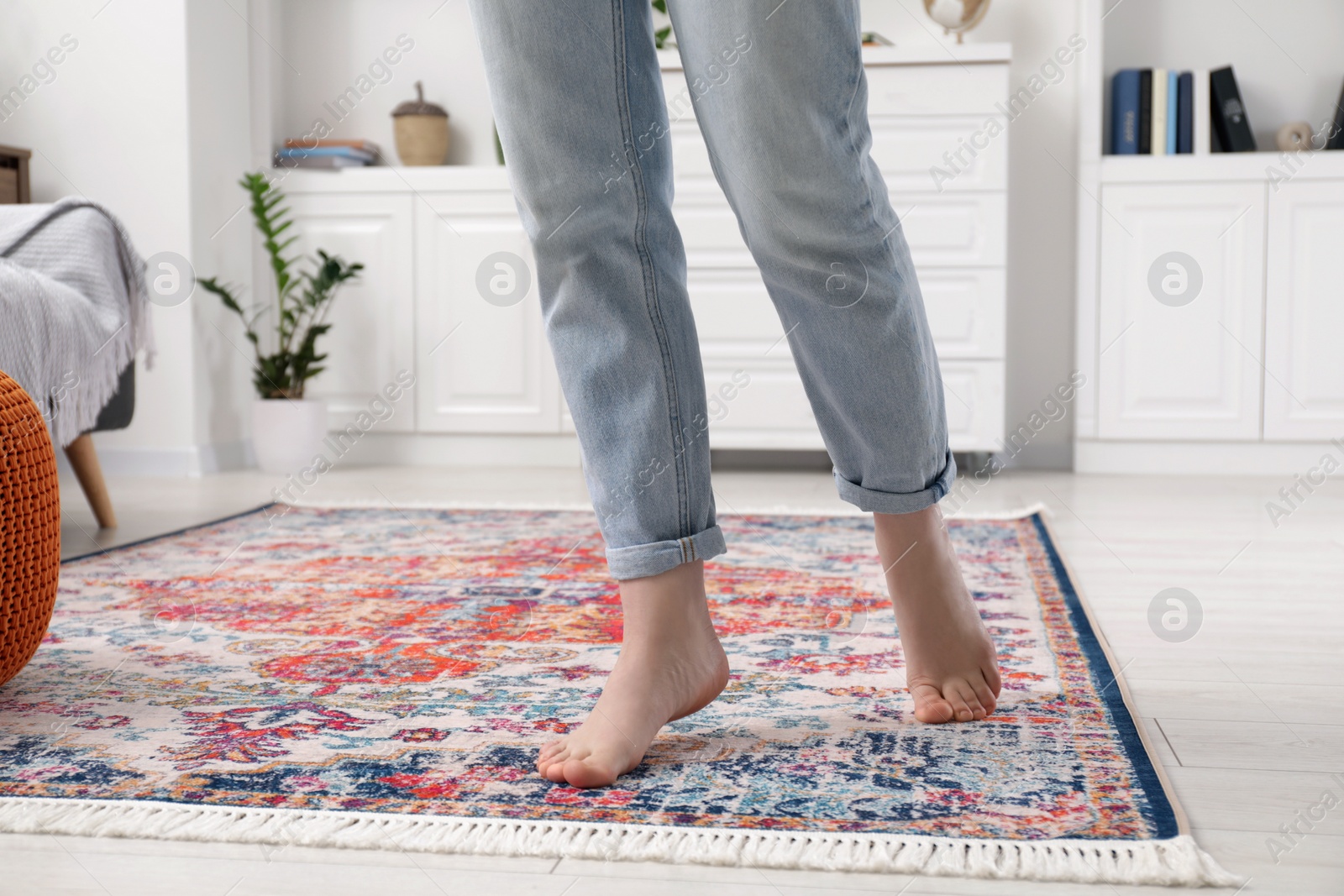 Photo of Woman standing on carpet with pattern in room, closeup. Space for text