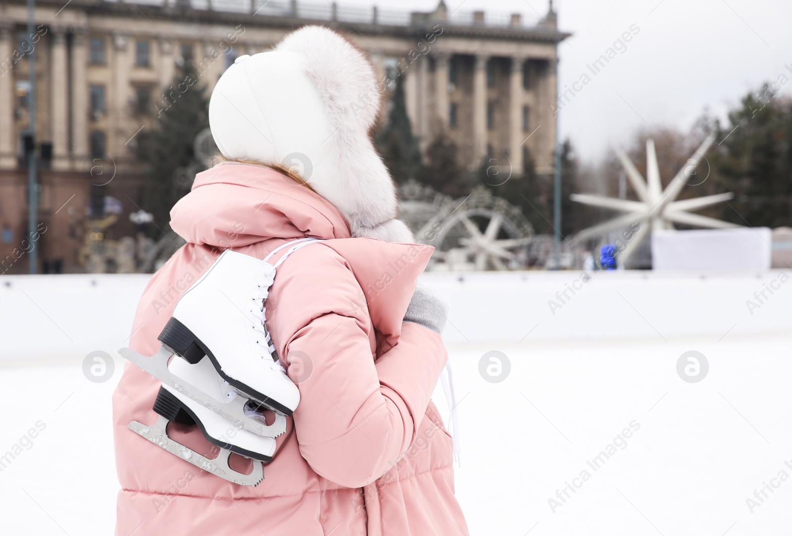 Image of Woman with figure skates near ice rink outdoors. Space for text