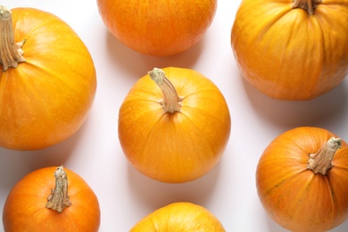 Fresh ripe pumpkins on white background, top view. Holiday decoration