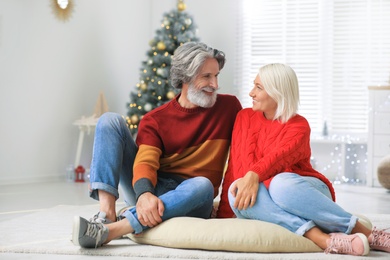 Happy mature couple celebrating Christmas at home