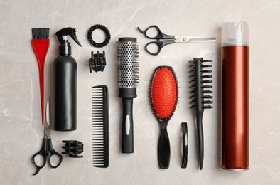 Photo of Flat lay composition with professional hairdresser tools on grey background
