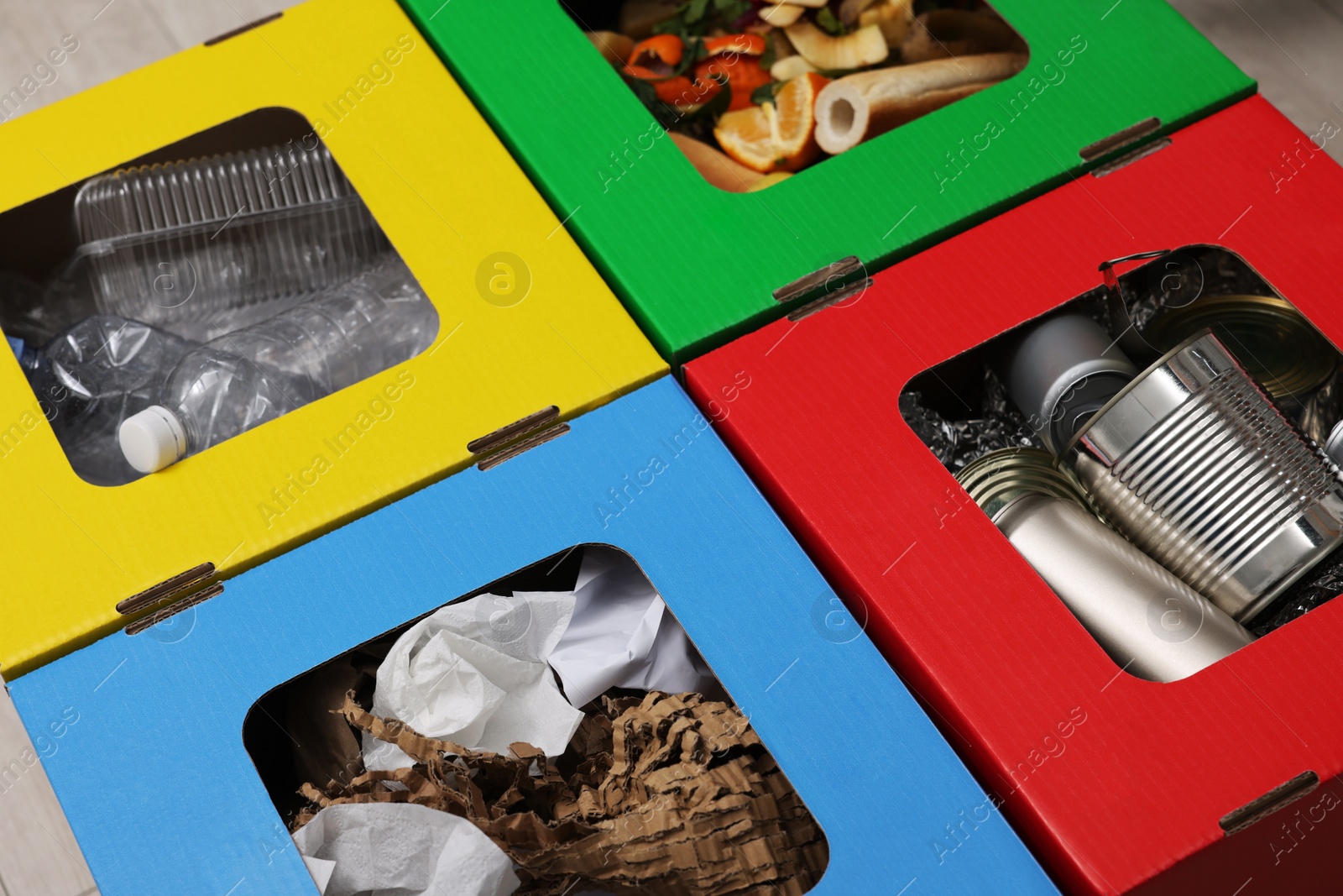 Photo of Garbage sorting. Full trash bins for separate waste collection indoors, closeup view