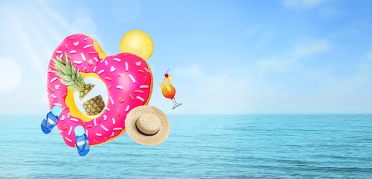 Image of Pineapple, cocktail and beach accessories flying against seascape. Banner design with space for text