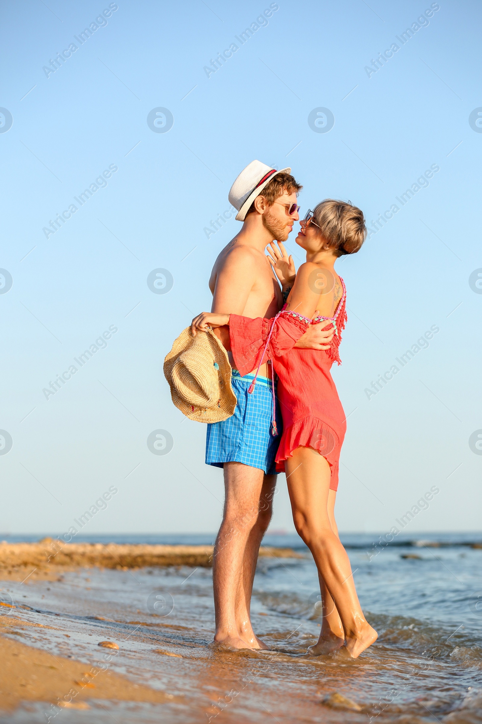 Photo of Happy young couple near water on beach