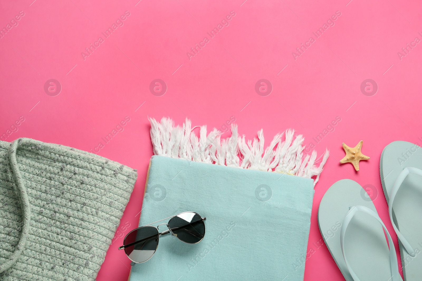 Photo of Flat lay composition with different beach objects on pink background, space for text