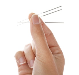 Photo of Woman holding needles for acupuncture on white background