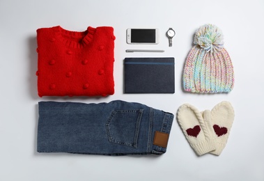 Photo of Flat lay composition with female winter clothes on white background