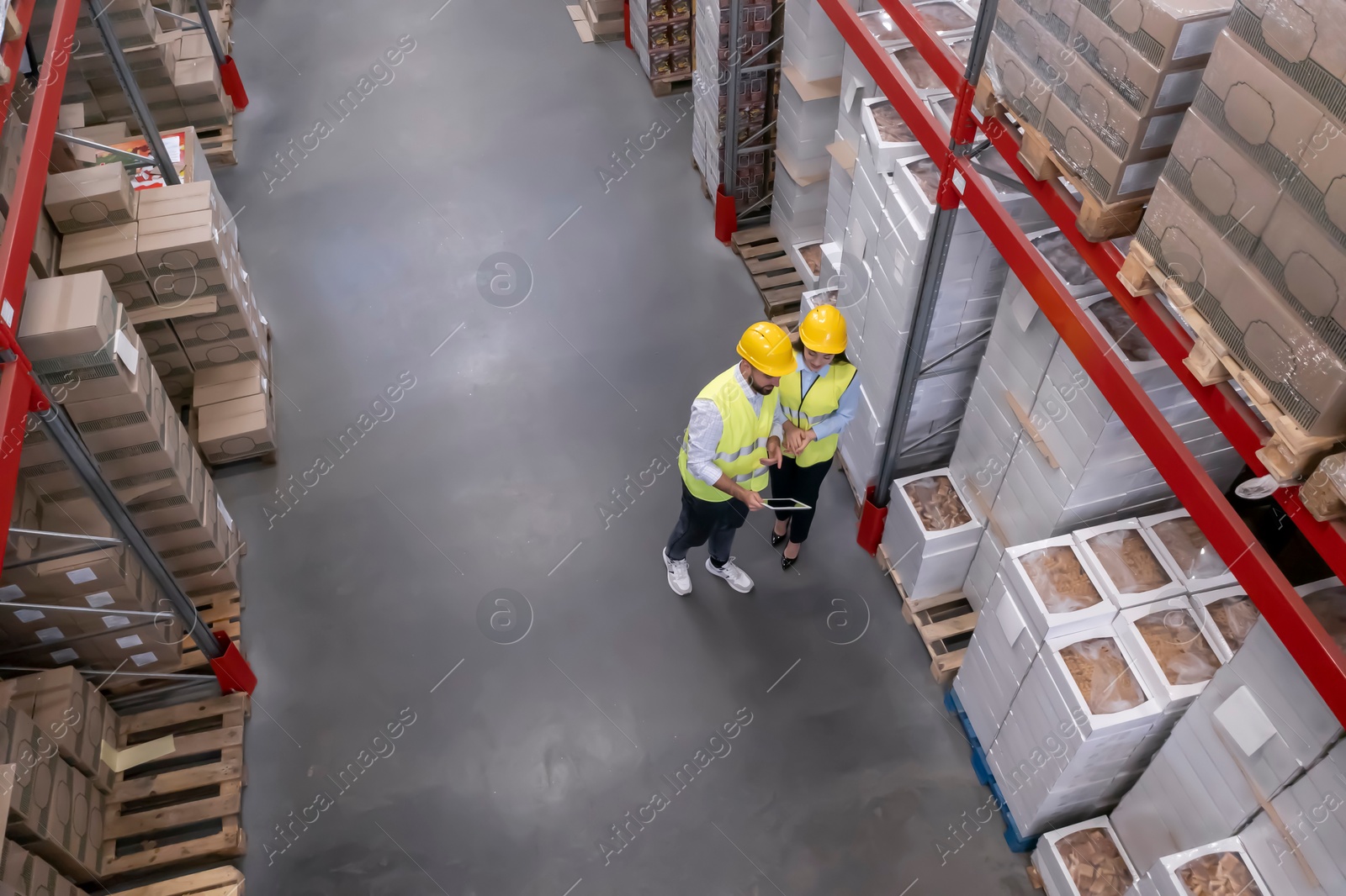 Image of Manager and worker at warehouse, above view. Logistics center
