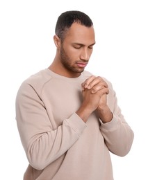 Photo of African American man with clasped hands praying to God on white background