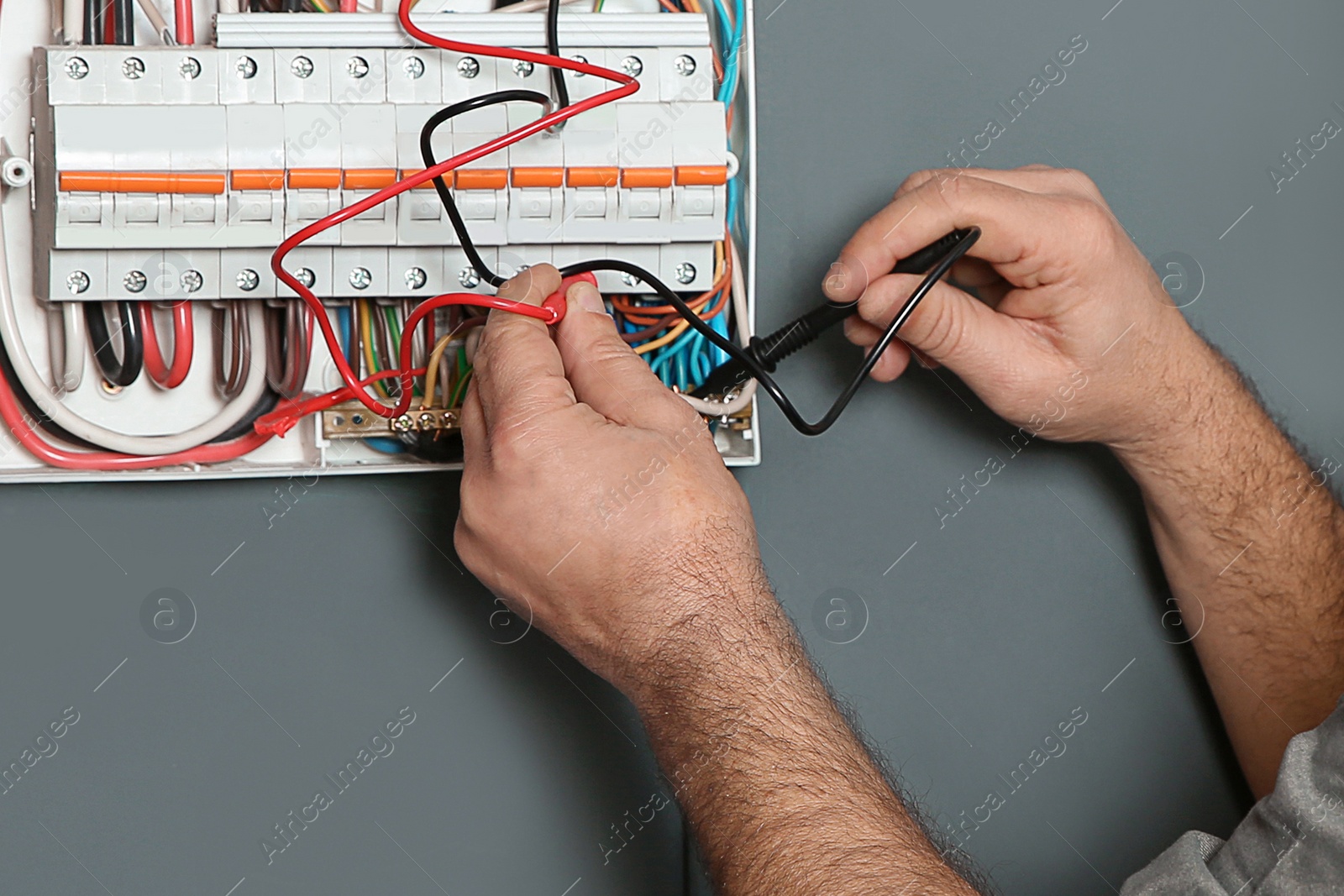 Image of Electrician with tester checking voltage indoors, closeup