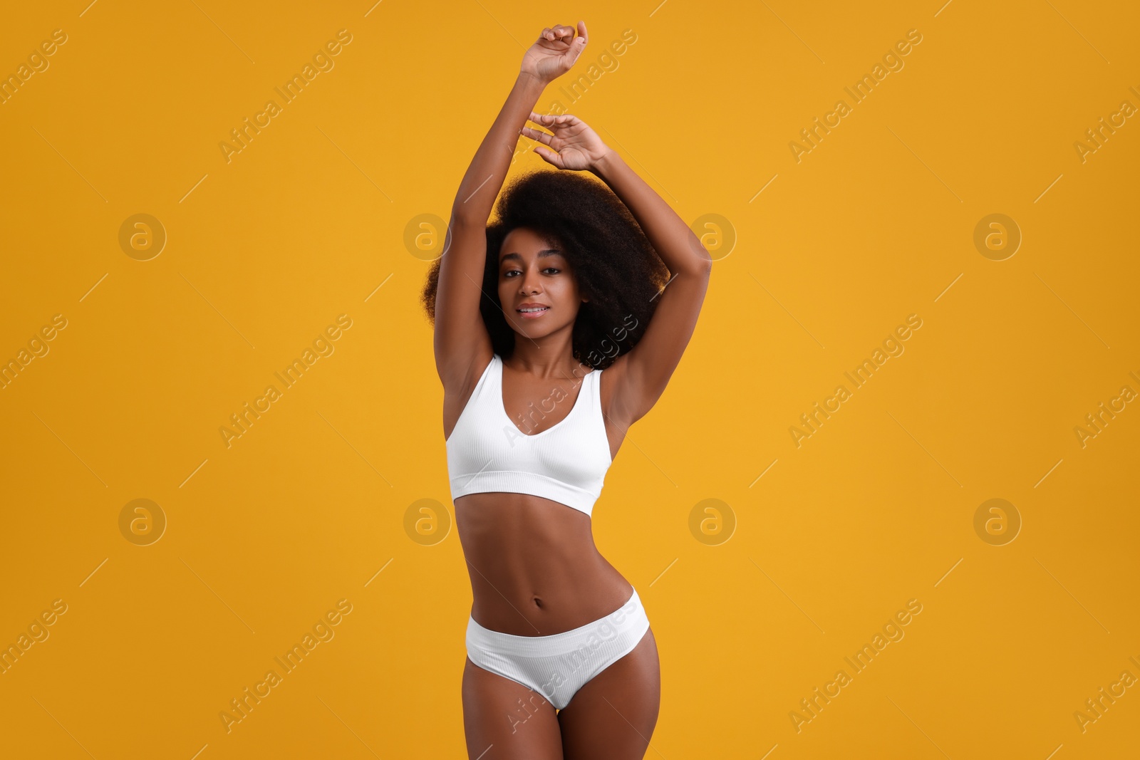 Photo of Beautiful woman in stylish bikini on yellow background