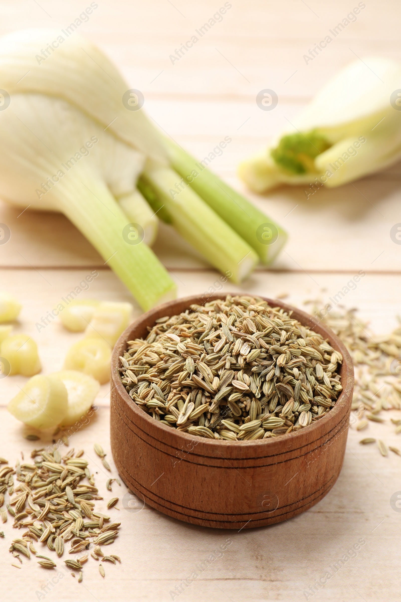 Photo of Bowl with fennel seeds on wooden table, closeup