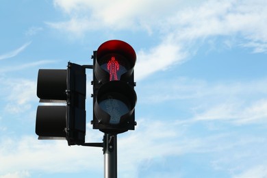 Photo of Pedestrian traffic light with red signal against blue sky, space for text