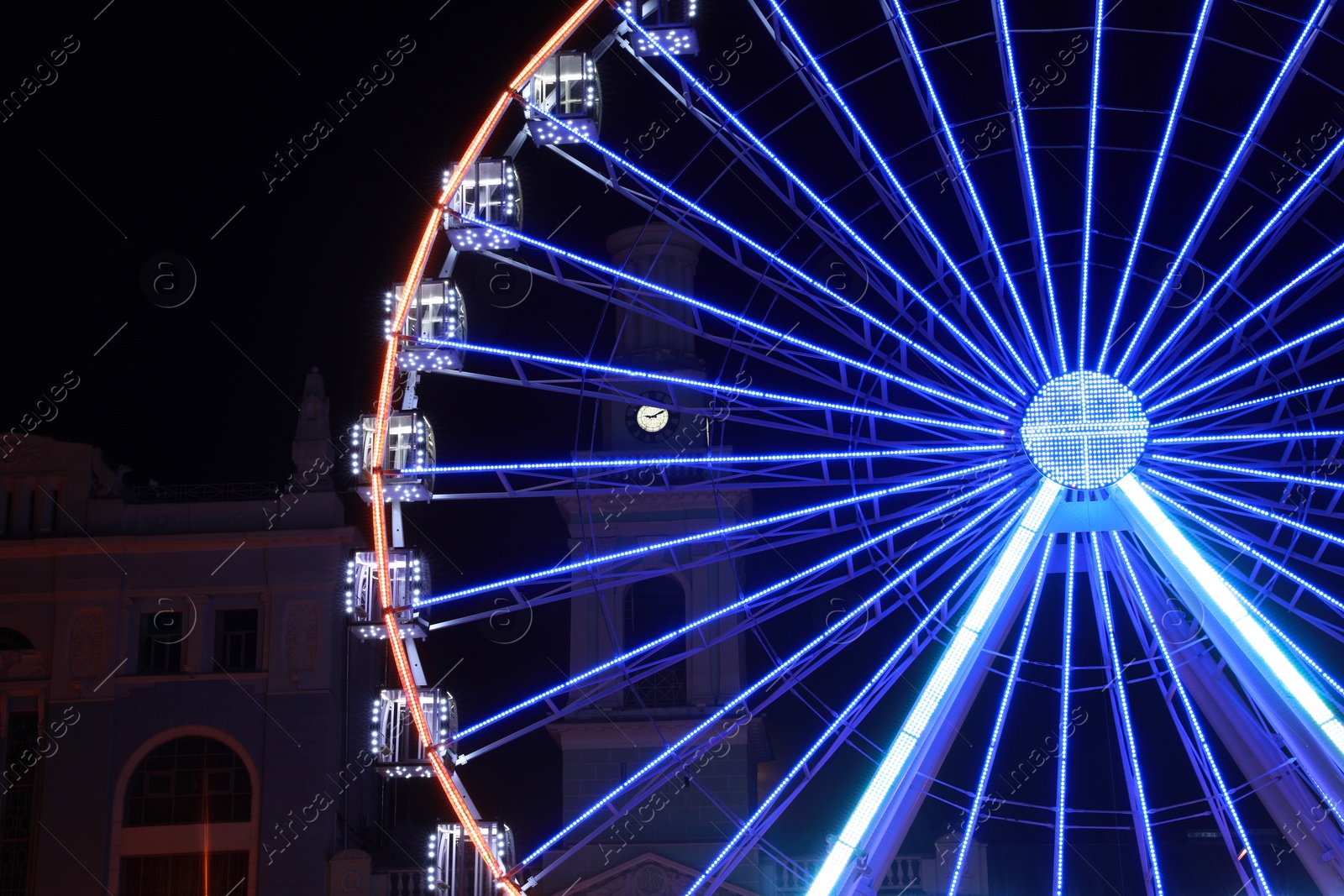 Photo of Beautiful glowing Ferris wheel in city at night
