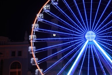 Photo of Beautiful glowing Ferris wheel in city at night