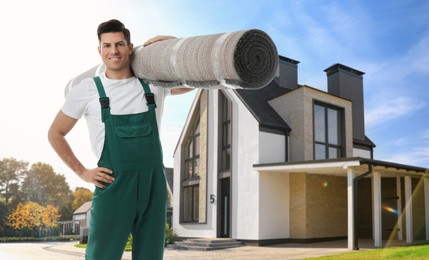 Image of Worker with rolled carpet outdoors on sunny day