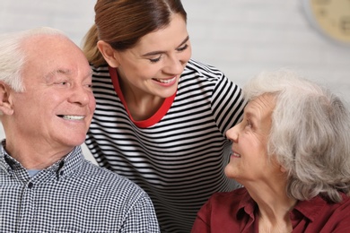 Photo of Elderly couple with female caregiver at home