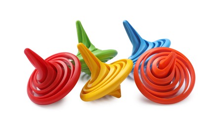 Photo of Many colorful spinning tops on white background