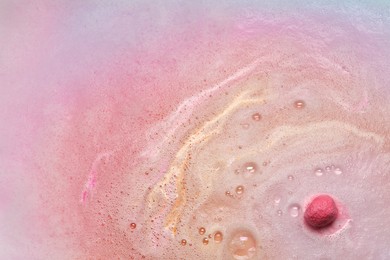 Beautiful pink bath bomb dissolving in water