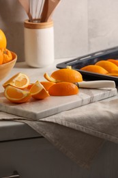 Photo of Fresh orange peels and juicy fruits on white table