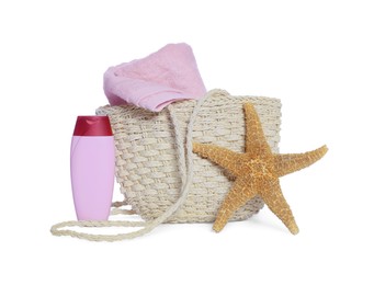 Photo of Wicker beach bag, starfish, sunscreen and towel isolated on white