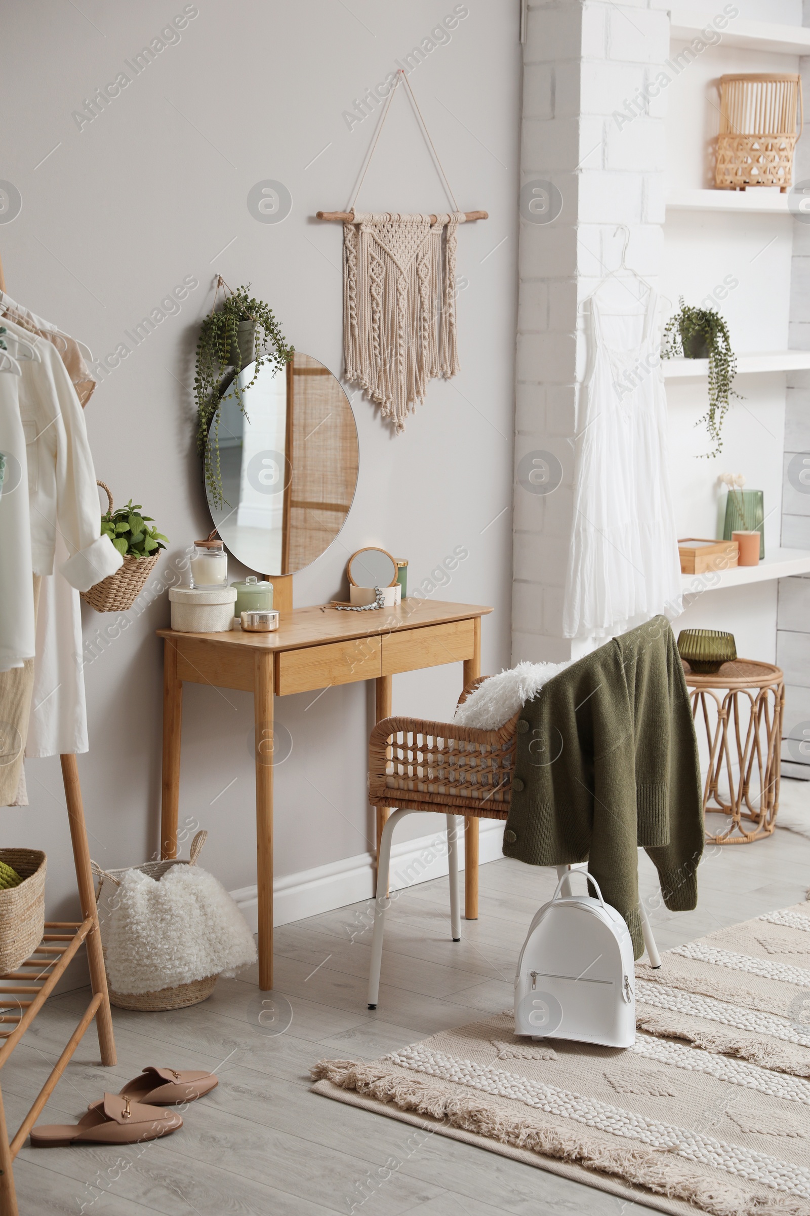 Photo of Wooden dressing table with decorative elements in room. Interior design