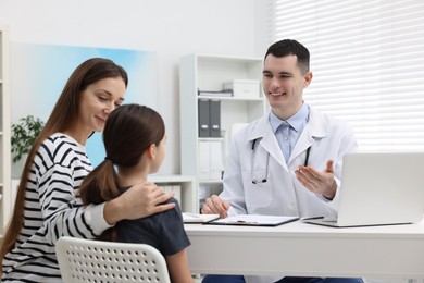 Gastroenterologist consulting woman and her daughter in clinic