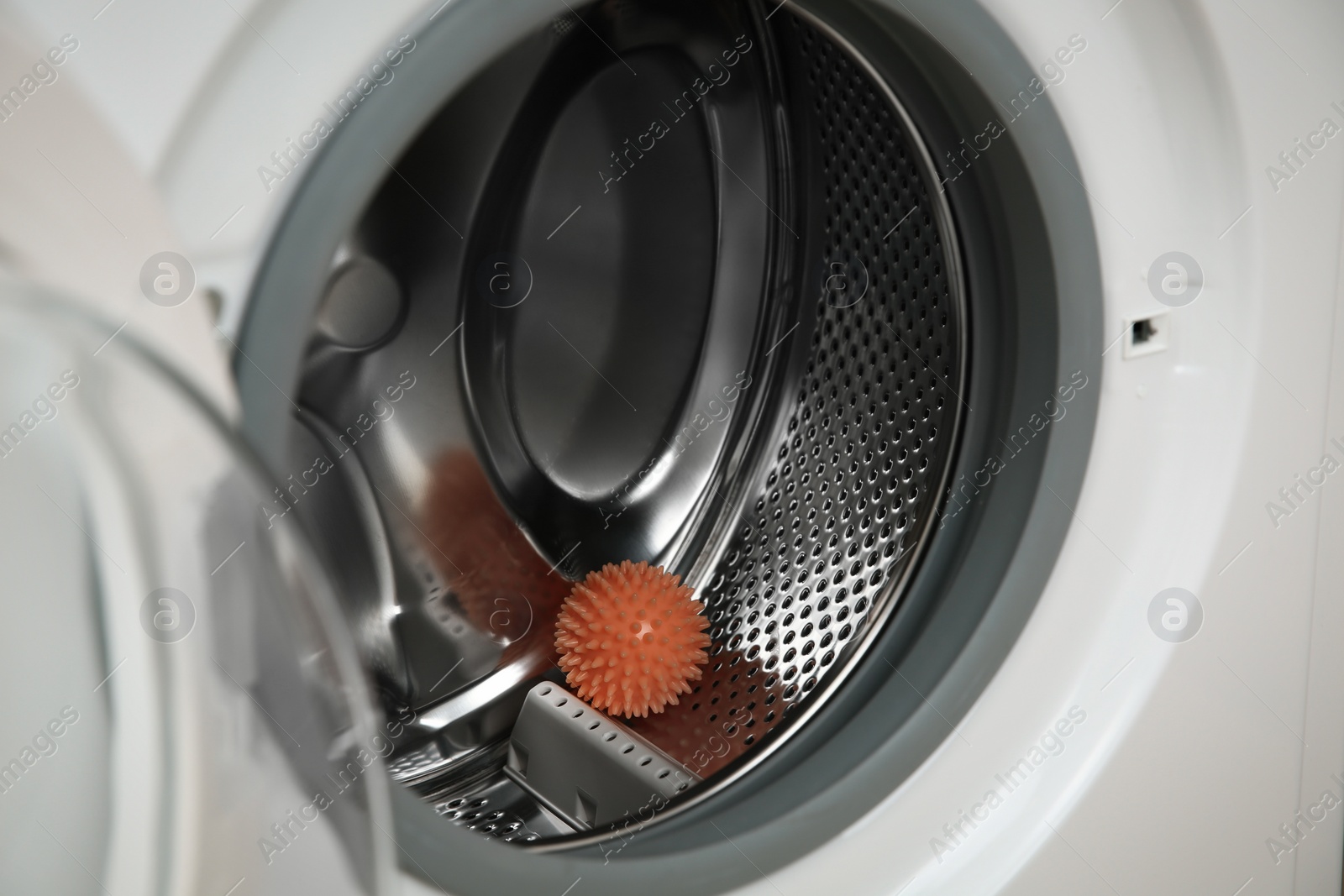 Photo of Dryer ball in washing machine drum, closeup