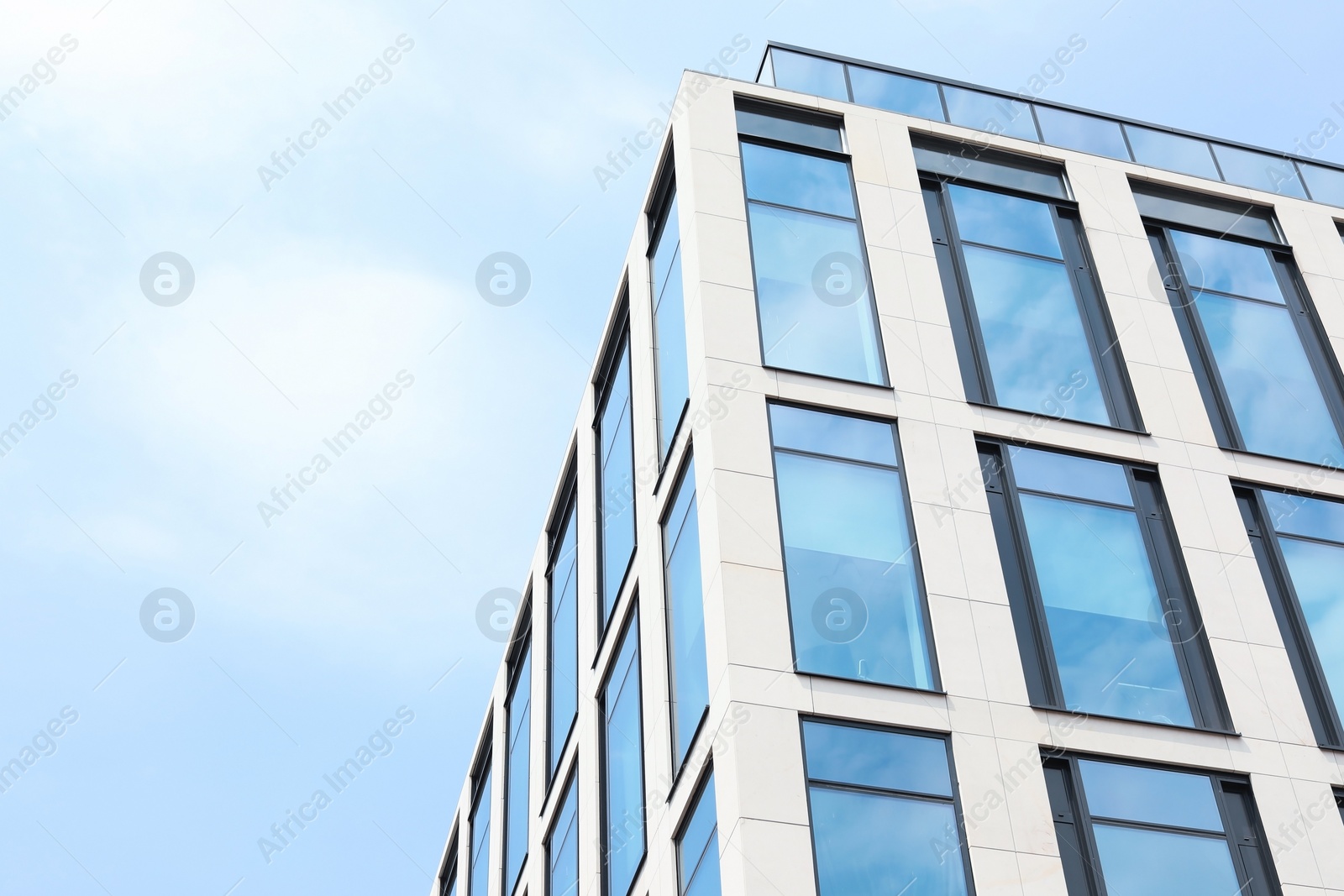 Photo of Building with tinted windows, outdoors. Modern architectural design