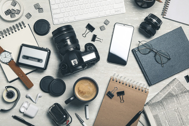 Image of Flat lay composition with equipment for journalist on light table
