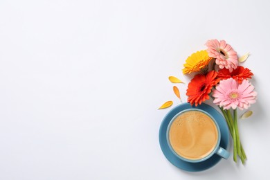 Photo of Beautiful colorful gerbera flowers, petals and cup of coffee on white background, flat lay. Space for text