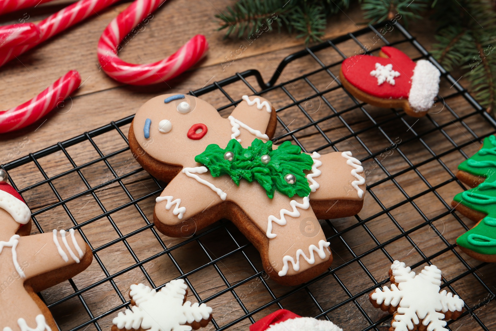 Photo of Delicious Christmas cookies and candies on wooden table, closeup