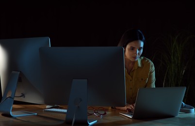 Programmer working in modern office at night
