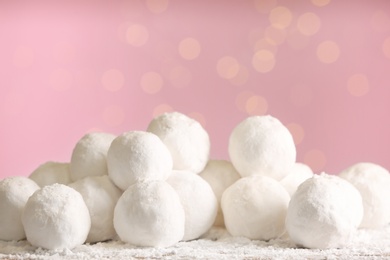 Photo of Round snowballs on table against blurred lights