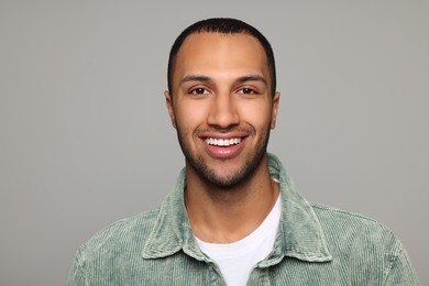 Portrait of smiling African American man on light grey background