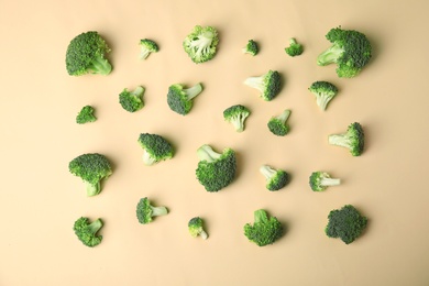 Photo of Flat lay composition with fresh green broccoli on color background