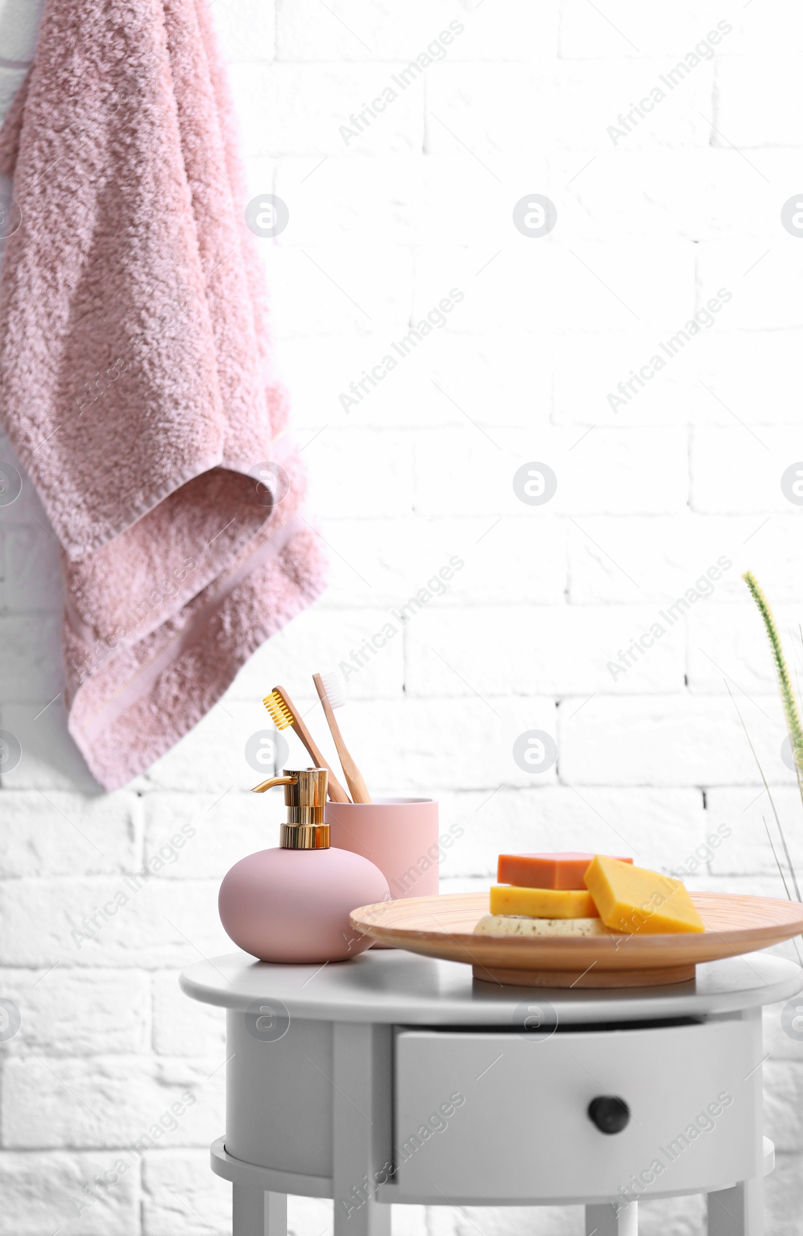 Photo of Soap bars, shampoo and toiletries on table in bathroom. Space for text