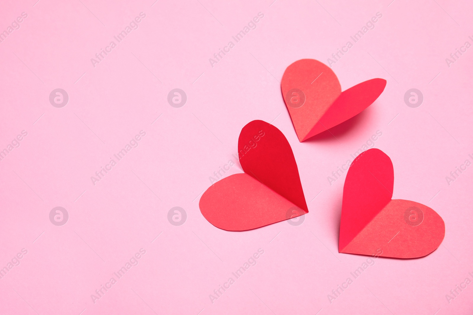 Photo of Small paper hearts on color background