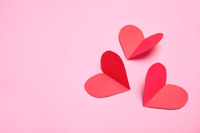 Photo of Small paper hearts on color background