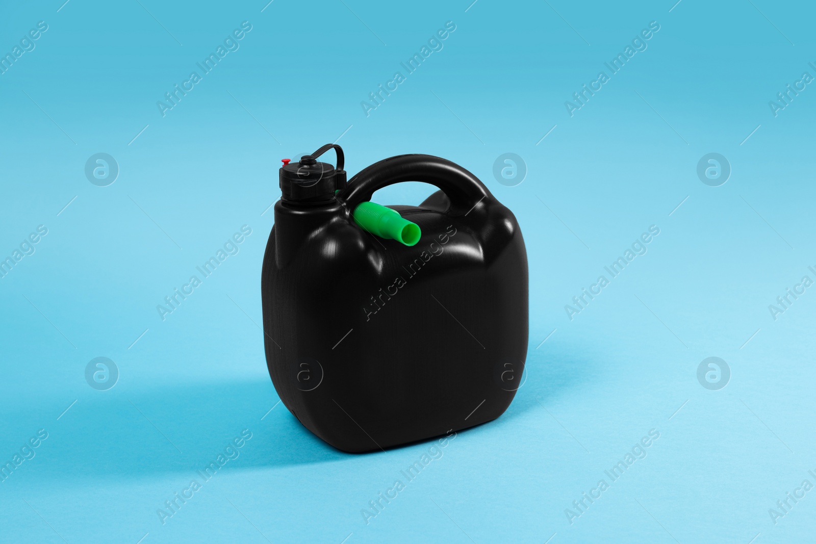 Photo of New black plastic canister on light blue background